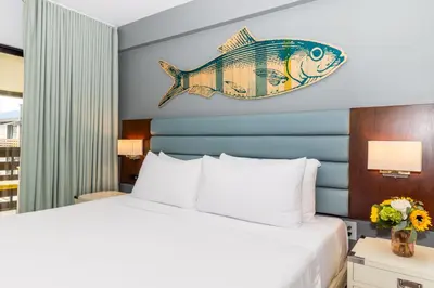 a hotel room with a bed with a fish on the wall at Lakehouse Resort in San Marcos