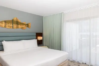 a bedroom with a bed with a fish on the wall at Lakehouse Resort in San Marcos