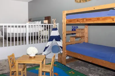 a kids room with a bunk bed and a table at Lakehouse Resort in San Marcos