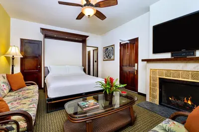 a hotel room with a bed and a fireplace at Pantai Inn in San Diego