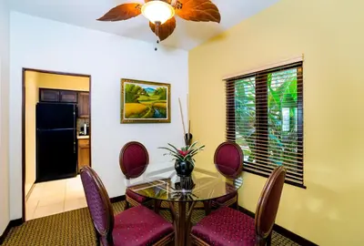 a dining room with a glass table and chairs at Pantai Inn in San Diego