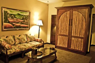 a living room with a couch and a door at Pantai Inn in San Diego