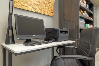 a desk with a computer and a printer on it at Best Western Plus Temecula Wine Country Hotel & Suites in Temecula