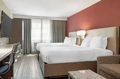 a hotel room with a large bed and a couch at Best Western Plus Temecula Wine Country Hotel & Suites in Temecula