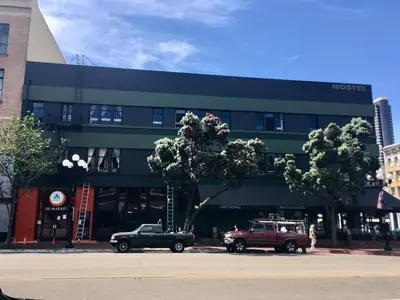 two cars parked in front of a building at HI San Diego Downtown Hostel in San Diego