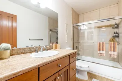 a bathroom with a sink and a toilet and a shower at Ocean Beach Pier Condo in San Diego