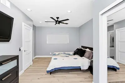 a bedroom with a bed and a ceiling fan at 308 35th Street, Unit A (Lower) in Newport Beach