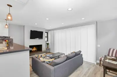 a living room with a couch and a fireplace at 308 35th Street, Unit A (Lower) in Newport Beach