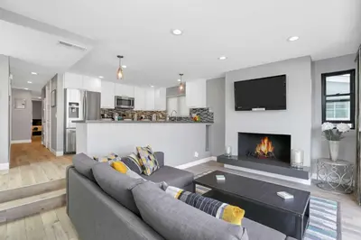 a living room with a couch and a fireplace at 308 35th Street, Unit A (Lower) in Newport Beach