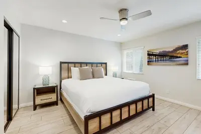 a bedroom with a large bed and a ceiling fan at Villa Del Mar in San Clemente