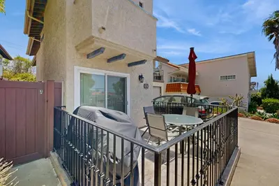 a balcony of a house with a table and chairs at Villa Del Mar in San Clemente