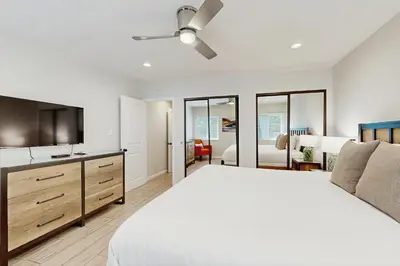 a bedroom with a bed and a ceiling fan at Villa Del Mar in San Clemente