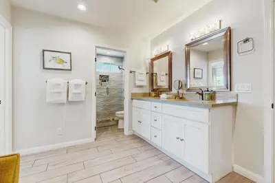 a bathroom with a sink and a toilet and a mirror at Villa Del Mar in San Clemente