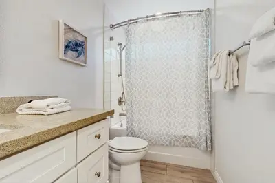 a white bathroom with a shower and a toilet at Villa Del Mar in San Clemente