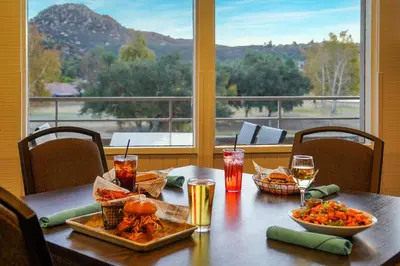 a table with food and drinks on it with a view at San Vicente Golf Resort in Ramona