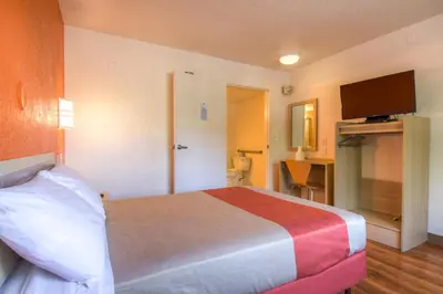 a hotel room with a bed and a flat screen tv at Motel 6-San Ysidro, CA - San Diego - Border in San Ysidro, San Diego