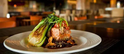 a white plate of food on a table at Cape Rey Carlsbad Beach, A Hilton Resort & Spa in Carlsbad