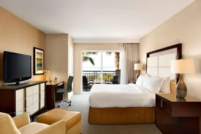 a hotel room with a bed and a television at Cape Rey Carlsbad Beach, A Hilton Resort & Spa in Carlsbad