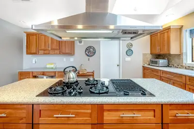 a kitchen with a stove with a tea kettle on it at Sunny Dreams Home in San Diego