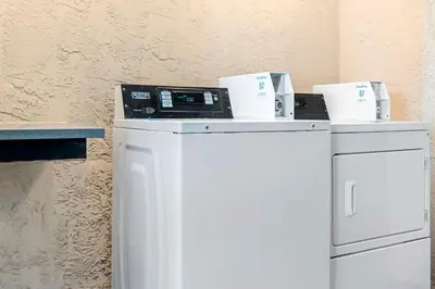 a kitchen with a dishwasher and a microwave at Best Western Santee Lodge in Santee