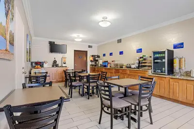 a restaurant with tables and chairs and a counter at Best Western Santee Lodge in Santee