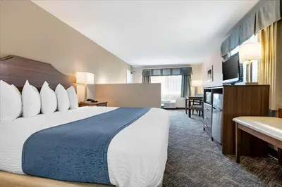 a hotel room with a large bed and a television at Best Western Santee Lodge in Santee