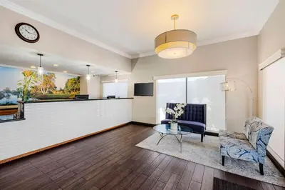 a living room with a chair and a table at Best Western Santee Lodge in Santee