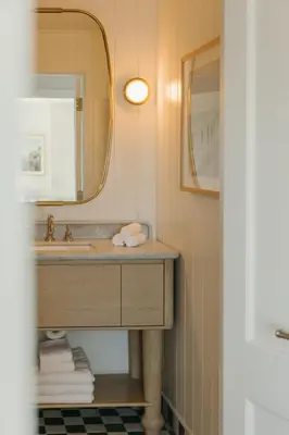 a bathroom with a sink and a mirror at Bay Shores Peninsula Hotel in Newport Beach