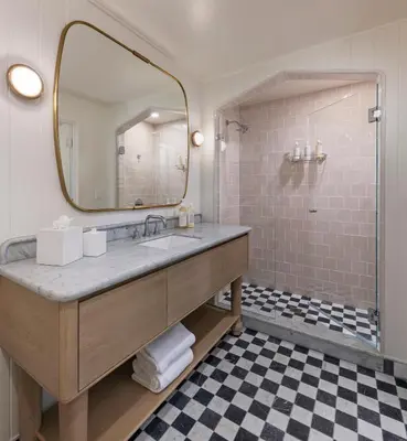 a bathroom with a sink and a mirror at Bay Shores Peninsula Hotel in Newport Beach