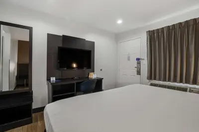 a hotel room with a bed and a television at Motel 6-Escondido, CA in Escondido