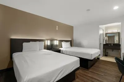 a hotel room with two beds and a mirror at Motel 6-Escondido, CA in Escondido
