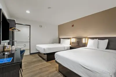 a hotel room with two beds and a flat screen tv at Motel 6-Escondido, CA in Escondido