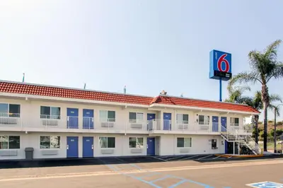 a hotel with a building with a sign on it at Motel 6-La Mesa, CA - San Diego in La Mesa