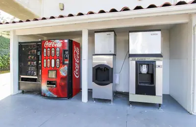 a coca cola machine and a drink dispenser in a building at Motel 6-La Mesa, CA - San Diego in La Mesa