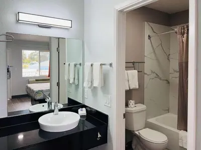 a bathroom with a sink and a toilet and a mirror at Motel 6-La Mesa, CA - San Diego in La Mesa