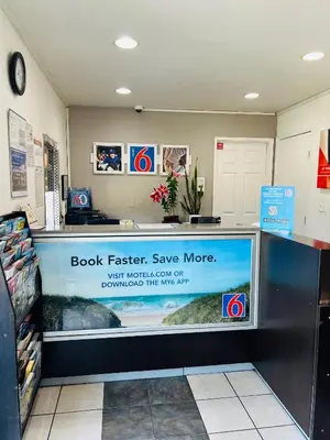 a book faster save more sign on a store counter at Motel 6-La Mesa, CA - San Diego in La Mesa