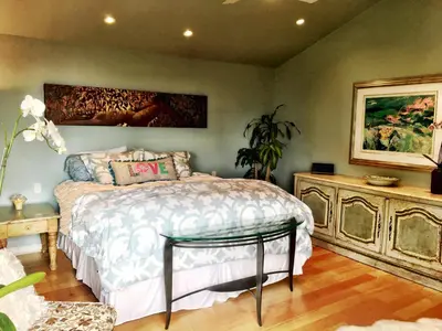 a bedroom with a bed and a painting on the wall at Rent Laguna Beach Sanctuary in Laguna Beach