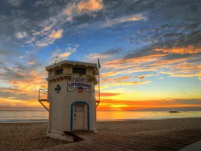 a light house on the beach at sunset at Rent Laguna Beach Sanctuary in Laguna Beach