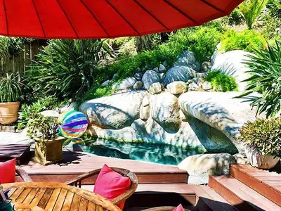 a garden with a fountain and an umbrella at Rent Laguna Beach Sanctuary in Laguna Beach