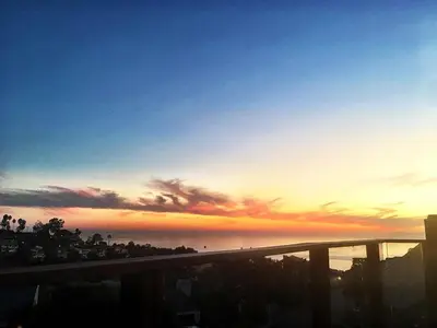 a sunset over the ocean and a freeway at Rent Laguna Beach Sanctuary in Laguna Beach