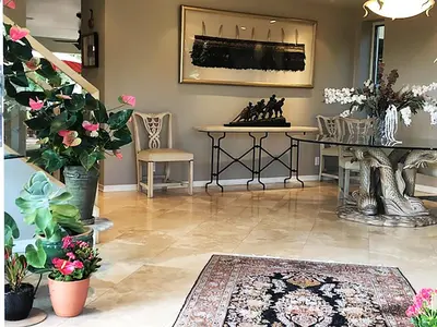 a living room with a table and chairs and flowers at Rent Laguna Beach Sanctuary in Laguna Beach