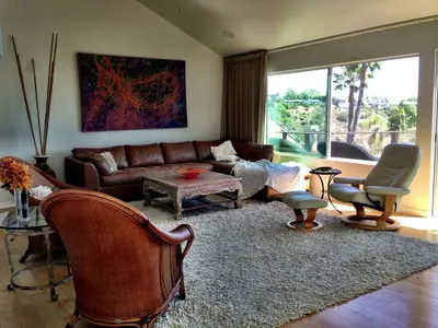 a living room with a couch and a table and chairs at Rent Laguna Beach Sanctuary in Laguna Beach