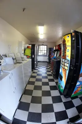 a room with a checkered floor and a refrigerator at EZ 8 Motel Old Town in San Diego