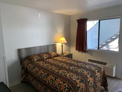 a hotel room with a bed and a window at EZ 8 Motel Old Town in San Diego