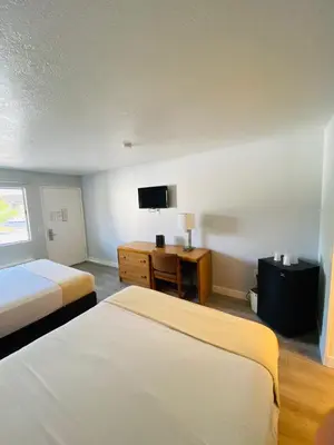 a hotel room with two beds and a television at EZ 8 Motel Old Town in San Diego