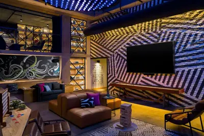 a living room with a flat screen tv on a wall at Moxy San Diego Gaslamp Quarter in San Diego