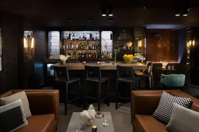 a bar in a restaurant with chairs and a counter at Moxy San Diego Gaslamp Quarter in San Diego