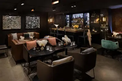 a restaurant with tables and chairs and a bar at Moxy San Diego Gaslamp Quarter in San Diego
