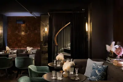 a restaurant with tables and chairs and a mirror at Moxy San Diego Gaslamp Quarter in San Diego