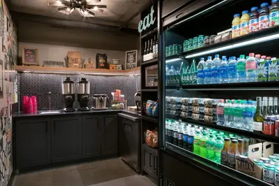 a bar with a lot of bottles of drinks at Moxy San Diego Gaslamp Quarter in San Diego